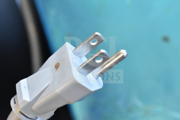 Close-up of a power plug for the 2024 Solwave 180MW1000SS Commercial Microwave, showing minor surface imperfections.