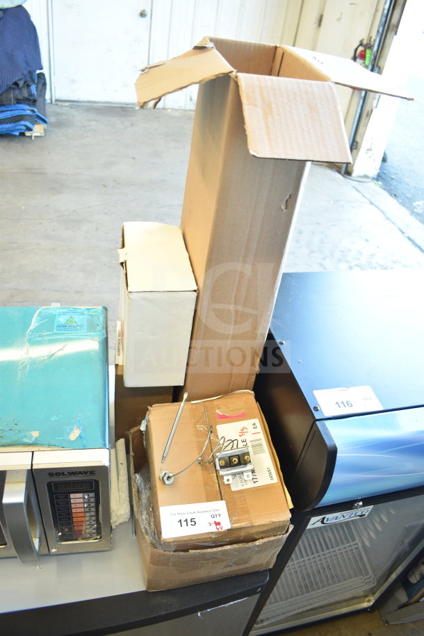 Assorted culinary parts and equipment including Adcraft Hi Limit, Avantco feed chute pusher, and more, in packing boxes.