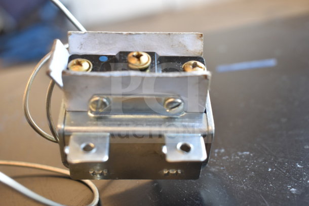 A metal component with wires and screws, in new condition, part of a bundle including Adcraft, Avantco, and other brands.