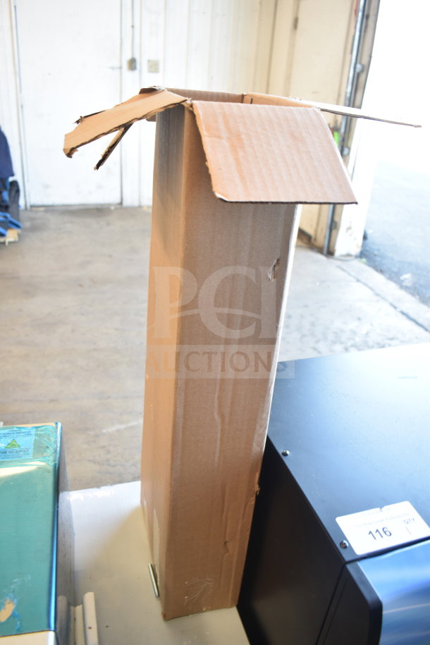 Cardboard box with lid open, containing six new scratch and dent items, including Adcraft Hi Limit and Avantco slicer parts.