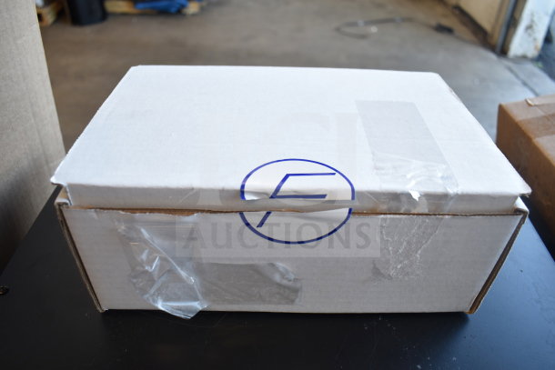 A sealed white box with "F" logo, part of a lot including six new scratch and dent kitchen items such as slicers and faucets.