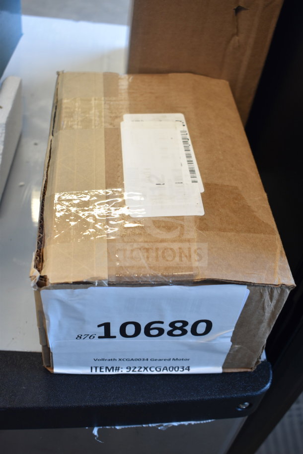 Brown cardboard box labeled "10680" containing Vollrath XCGA0034 Geared Motor. New condition, boxed.