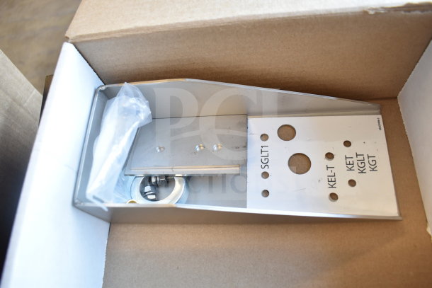 Stainless steel rectangular component with holes and markings "SGLT1", "KEL-T" in a box, brand new condition.