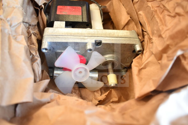 Vollrath XCGA0034 Geared Motor in packaging, new condition, includes visible labels and parts.