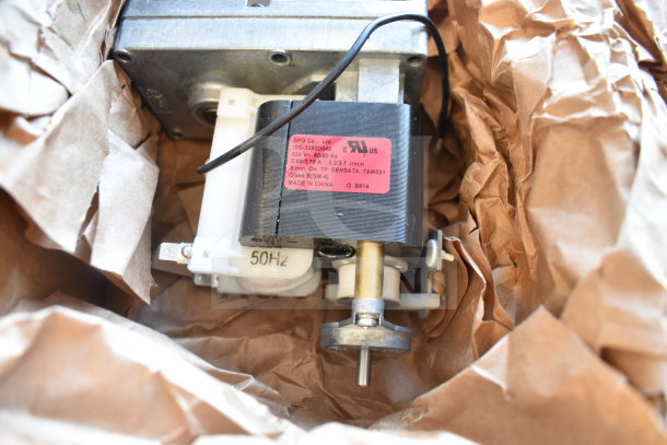 New Vollrath XCGA0034 Geared Motor, 50Hz, detailed label, nestled in brown packaging paper.