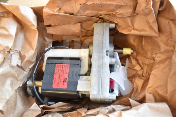 Vollrath XCGA0034 Geared Motor in new condition, partially wrapped in brown paper, with visible labels and wiring.