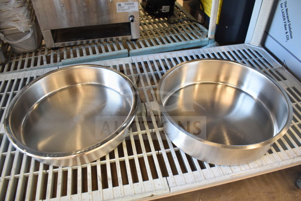 "Brand new scratch and dent round chafer dish; stainless steel, reflective finish, two pieces, slight imperfections visible."
