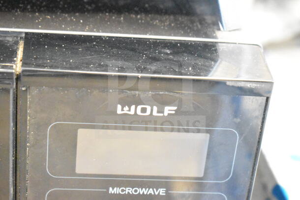 Wolf MWC24 Countertop Microwave Oven. Black finish, model MWC24, 120V, 1 phase. Gently used condition.