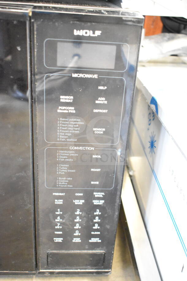 Wolf MWC24 microwave oven, countertop model, 120 volts, 1 phase. Features sensor cook, convection settings, and control panel details.