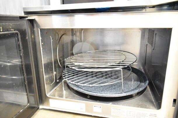 Wolf MWC24 countertop microwave oven, stainless steel interior, 120 volts, visible racks, lightly used condition.