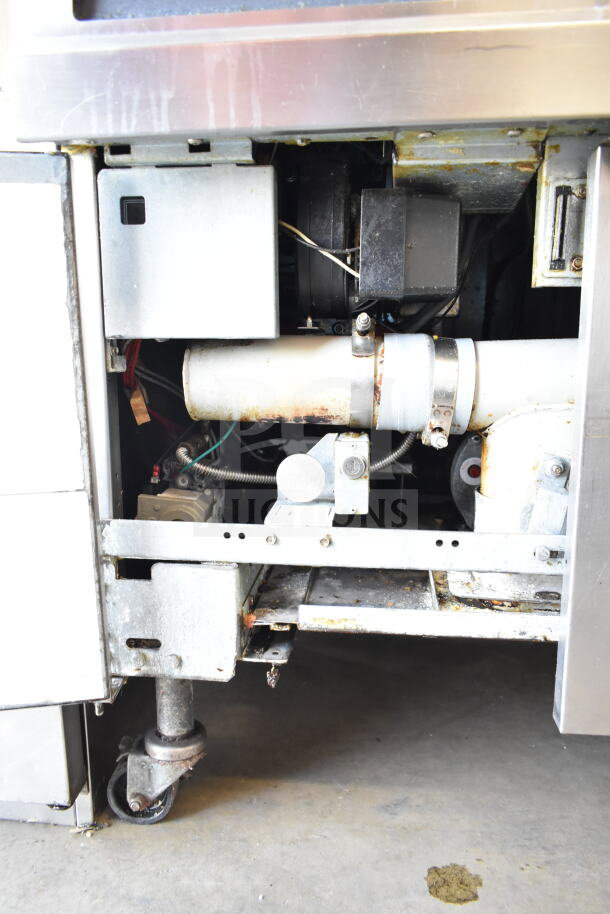 Frymaster BIGLA430CSD commercial 3-bay gas fryer. Features robust casters, showing internal components, worn condition.