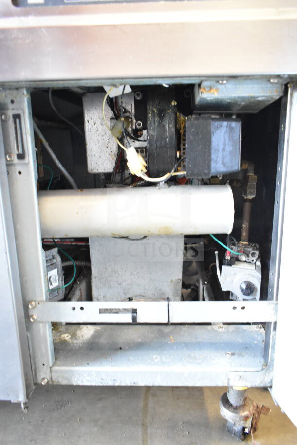Frymaster BIGLA430CSD commercial 3 bay fryer, natural gas powered, on casters, internal components visible, used condition.
