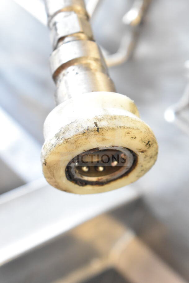 Close-up of Frymaster BIGLA430CSD fryer component showing wear. Part of a 3 bay, natural gas fryer on casters.