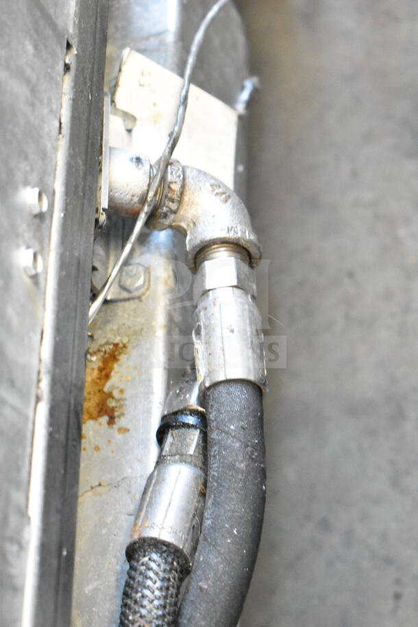 Frymaster BIGLA430CSD fryer natural gas connection, showing metal fittings and hose, in a used condition.