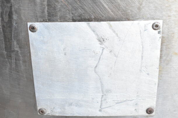 Pitco Frialator commercial gas fryer, stainless steel, visible wear. Metal tag shows "NATURAL" and serial details.