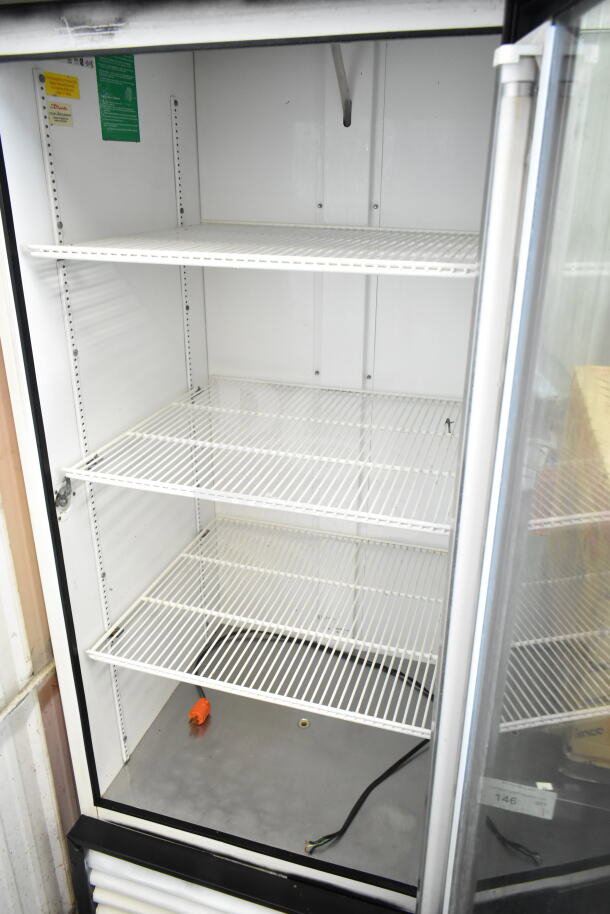 True GDM-26 commercial single door cooler merchandiser, 115 volts, 1 phase. Four shelves, visible interior labels, used condition.