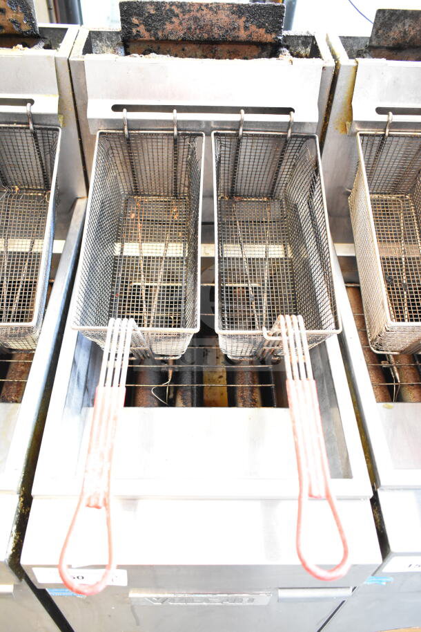 Vulcan commercial gas fryer with two fry baskets in used condition; features stainless steel construction, visible wear.