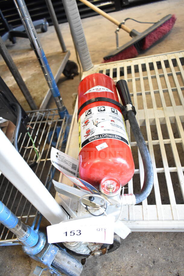 Amerex fire extinguisher, red, with hose and pressure gauge; requires pickup. Safety instructions and label showing.