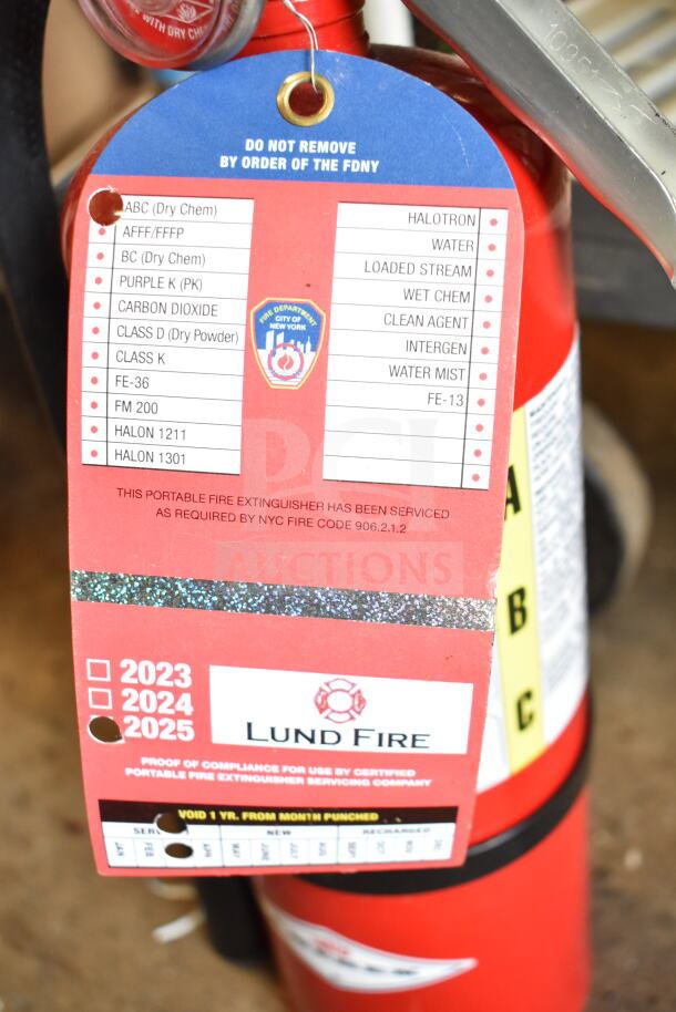 Amerex fire extinguisher with service tags, compliance checked for NYC Fire Code 906.2.1.2, pick-up required.