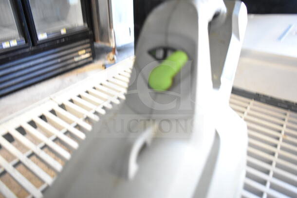 EGo Power+ battery powered blower, close-up. Features green trigger, ergonomic design. Condition not clearly visible.