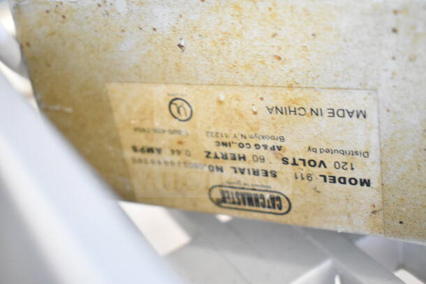 Close-up of a label on a bug zapper, showing "120 Volts, 60 Hertz, Model 911, Made in China" information.