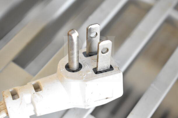 Close-up view of a three-prong plug from 5 various bug zappers, 120 volts, 1 phase, in used condition.