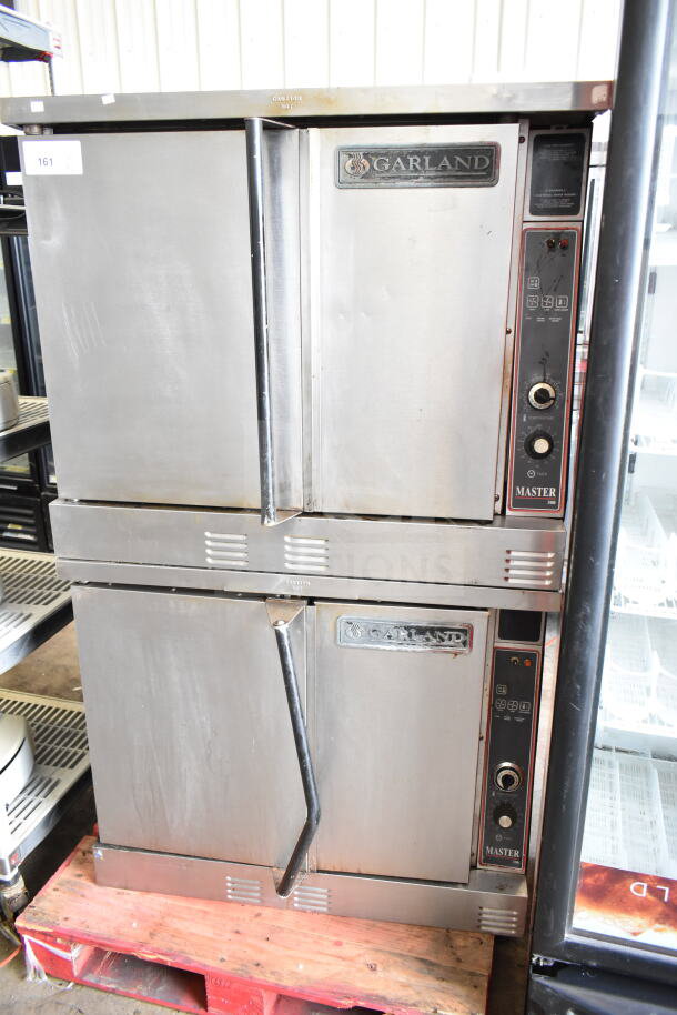Garland commercial full-size convection ovens with solid doors, thermostatic controls, visible Garland branding, used condition.
