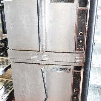 Garland commercial full-size convection ovens with solid doors, thermostatic controls, visible Garland branding, used condition.