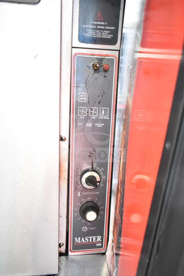 Garland commercial convection oven with solid doors, thermostatic controls, warning label, and visible wear. Model: Master 300.