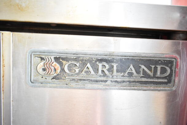 Garland commercial convection oven, full-size, solid doors, thermostatic controls, visible brand logo, used condition.