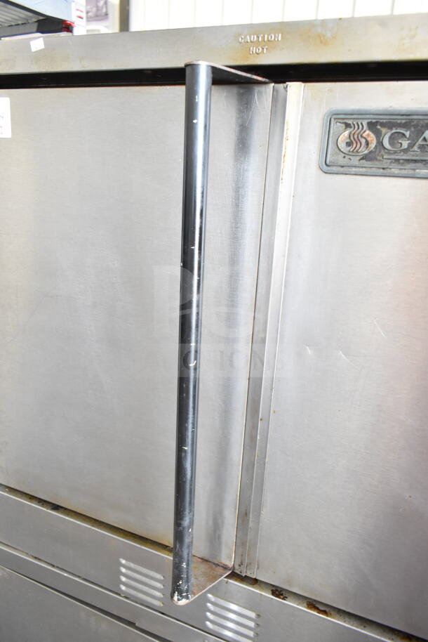 Garland commercial convection oven, solid doors, thermostatic controls, stainless steel, good condition, "Caution Hot" label.