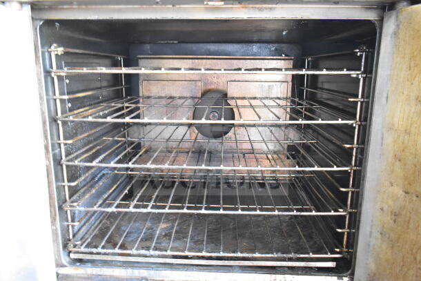 Garland commercial full-size convection oven interior with solid doors; features thermostatic controls and multiple wire racks.