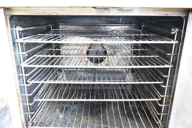 Garland commercial full-size convection oven with solid doors, thermostatic controls, and multiple wire racks, used condition.