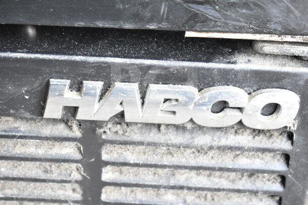 Habco ESM28 Cooler Merchandiser logo on dusty surface, highlighting brand authenticity.