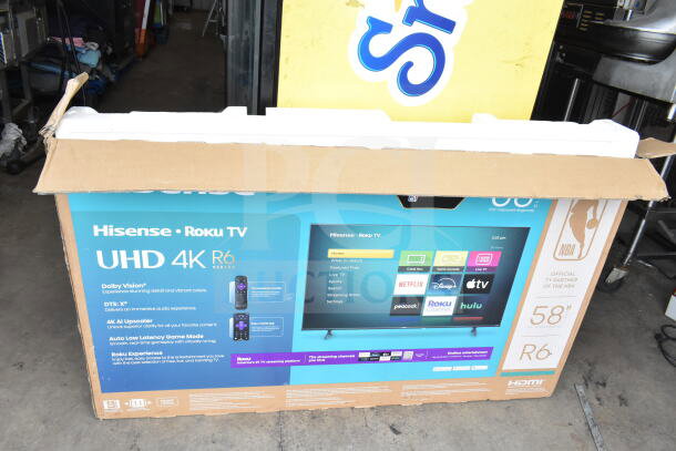 Hisense 58R6E5 UHD 4K 58" TV in original box. Features Dolby Vision, DTS:X, 4K AI Upscaler. R6 Series packaging visible.