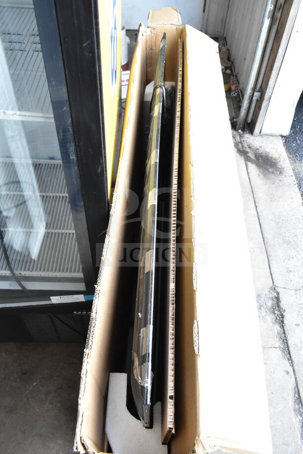 Hisense 58R6E5 UHD 4K 58" TV in original box, showing thin profile and protective packaging.