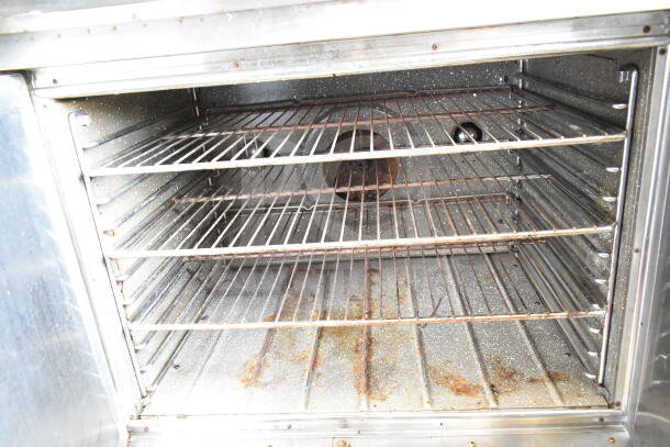Blodgett commercial gas convection oven interior with rust and wear. Shelves and fan visible.