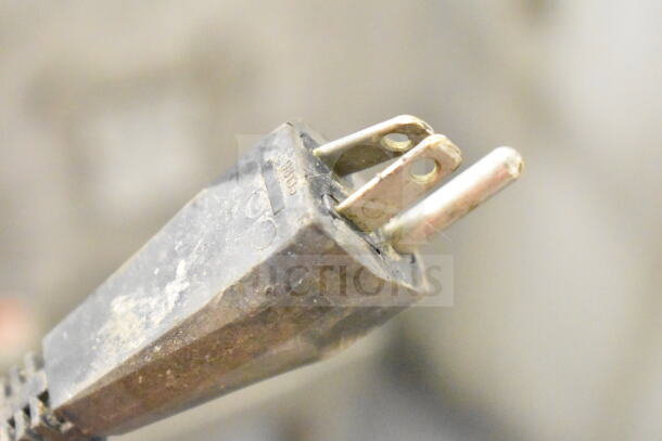 Close-up of a power plug, likely for an Electrolux TR24 Commercial Countertop Food Processor, showing wear and markings.