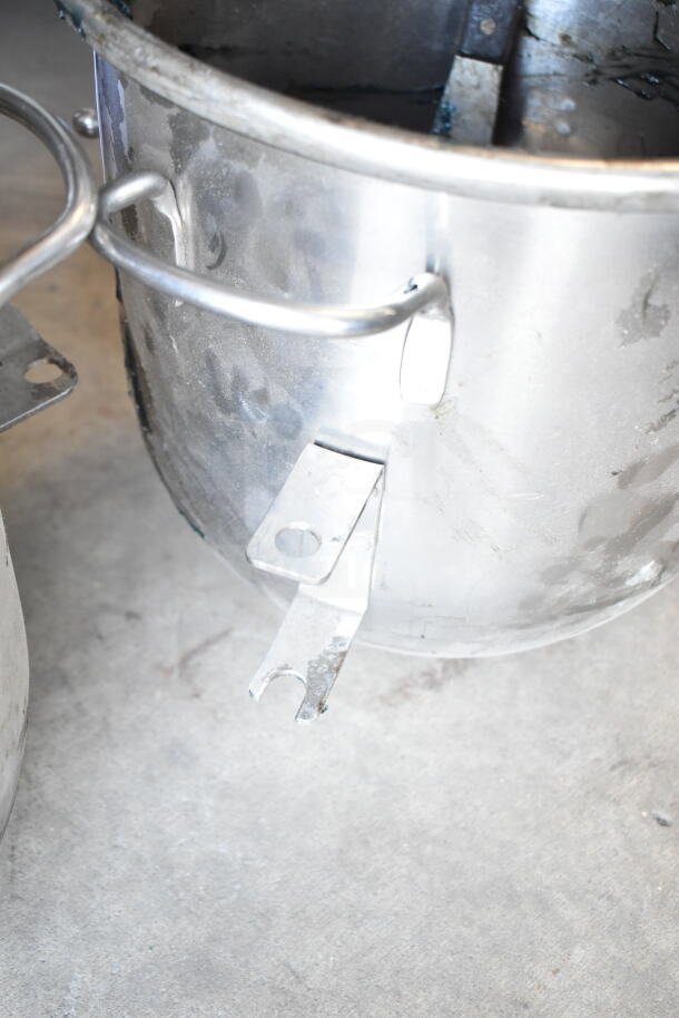 Stainless steel mixing bowls with handles and mount brackets, some surface wear, industrial use.