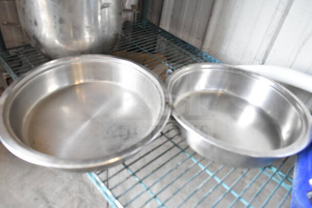 Stainless steel bowls on metal shelf, part of a lot including portafilters and poly bin. Lightly used condition.