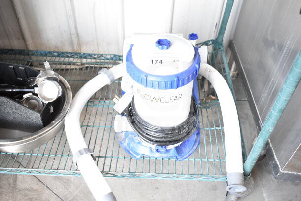 FlowClear 90403E Filter Pump, 110-120V, 1 Phase, good condition, visible hoses and power cord, labeled "FLOWCLEAR".