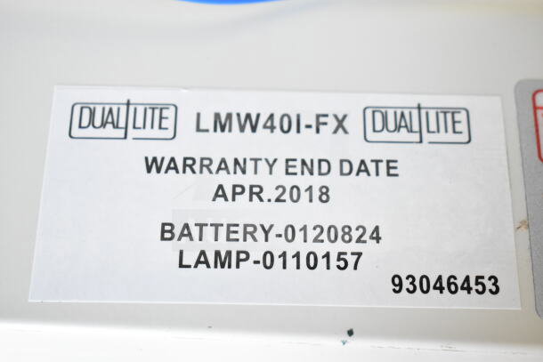 Dual Lite LMW40I-FW emergency light label showing warranty end date of April 2018, battery, and lamp numbers.