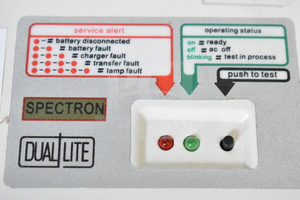 Dual Lite LMW40I-FW emergency light panel showing service alerts, operating status indicators, and a push-to-test button.