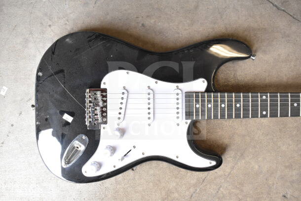 Two electric guitars, Cort and RockJam, in good condition; black finish with white pickguard visible.