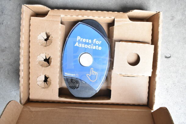 Cardboard box containing digital callbox with "Press for Associate" label, Walmart branding, circular speaker opening.