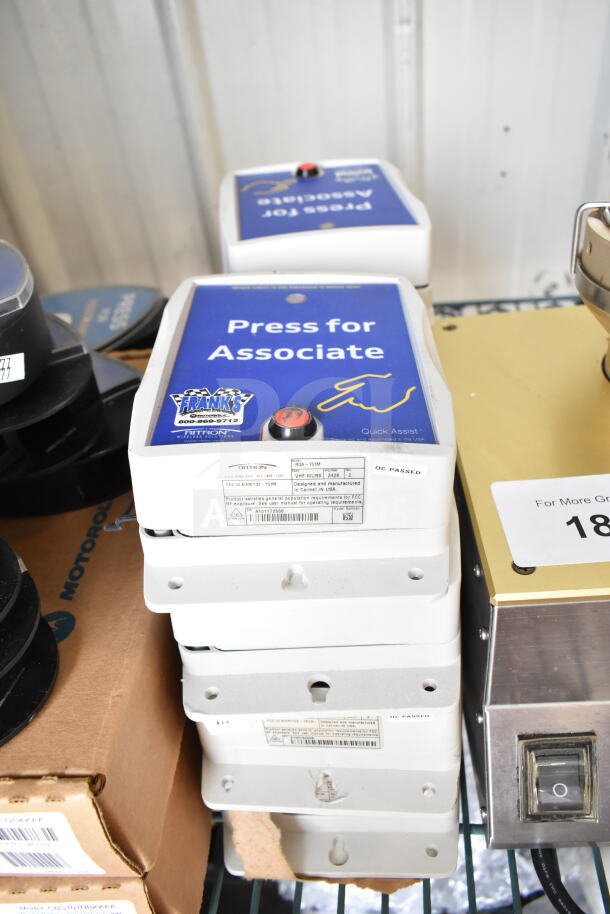Stack of CB300-D Digital Callboxes with "Press for Associate" label, white casing, minor wear, visible instruction labels.