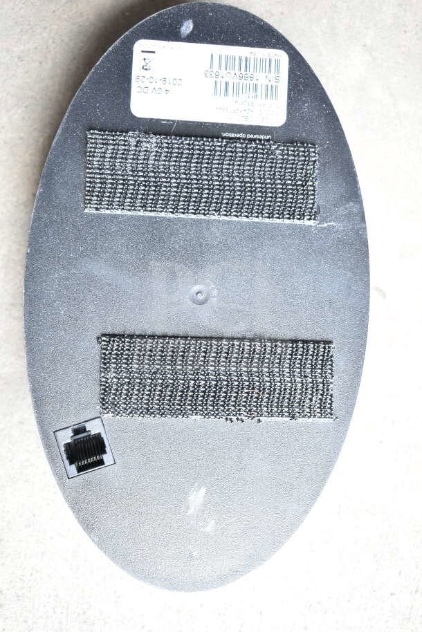 Back view of CB300-D Digital Callbox with barcode and serial number tag; features Ethernet port and Velcro attachments.