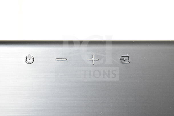 Samsung HW-T60MV Sound Bar controls, featuring power, volume, and input buttons on a sleek, silver surface.