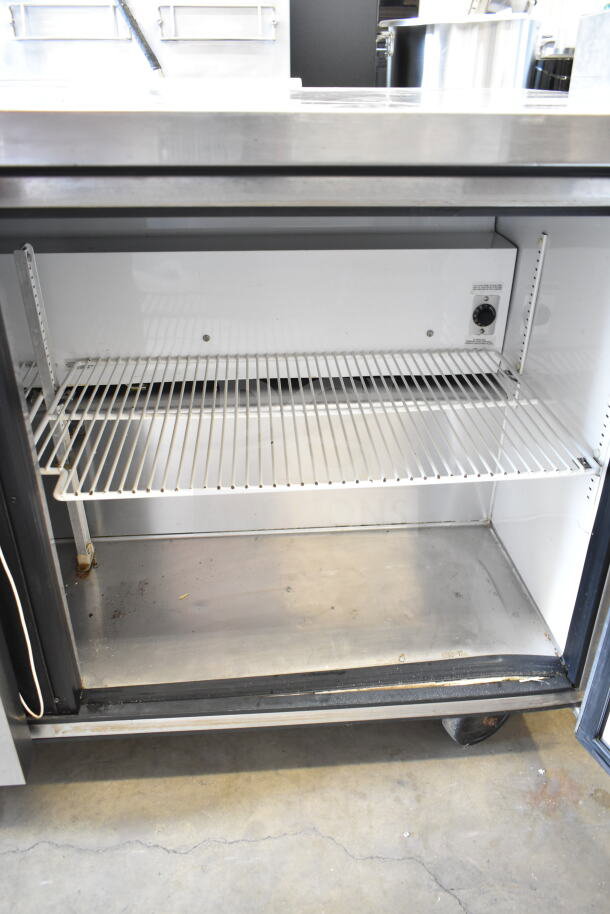 True TUC-60 commercial undercounter cooler, 2-door, 115 volts, 1 phase, interior with wire shelving, visible wear.