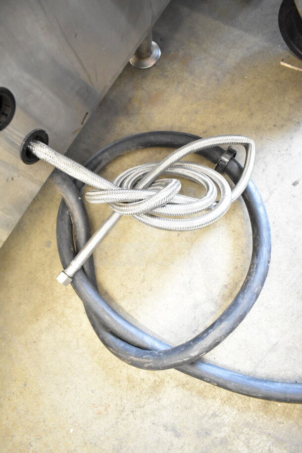 Fetco CBS-2052e20 coffee machine hoses and connections detail, showcasing braided and rubber tubing for functionality.